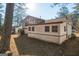An exterior shot of a two-story home with backyard that is covered in pine needles with trees behind it at 9100 Settlers Grove Ne Rd, Covington, GA 30014