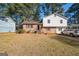 Charming two-story home with brick accents, lush trees, and inviting entrance at 9100 Settlers Grove Ne Rd, Covington, GA 30014
