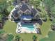 Aerial view of a beautiful estate with a swimming pool, manicured lawns, and mature trees at 310 Westbourne Dr, Tyrone, GA 30290