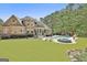 Gorgeous home with a sparkling pool, outdoor seating, and lush greenery in the backyard at 310 Westbourne Dr, Tyrone, GA 30290