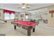 Basement with pool table, dartboard and casual seating area with ceiling fan at 310 Westbourne Dr, Tyrone, GA 30290