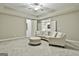 Large finished basement space with seating, neutral carpeting and a ceiling fan at 310 Westbourne Dr, Tyrone, GA 30290