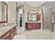 Elegant bathroom showcasing a double vanity with granite countertops and tiled shower at 310 Westbourne Dr, Tyrone, GA 30290