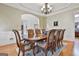 Formal dining room with hardwood floors, designer chandelier and an archway to the living area at 310 Westbourne Dr, Tyrone, GA 30290