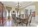 Formal dining room with hardwood floors, classic chandelier, and traditional decor for elegant gatherings at 310 Westbourne Dr, Tyrone, GA 30290