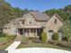 Charming exterior elevation of a brick home showcasing meticulous landscaping and an inviting entrance at 310 Westbourne Dr, Tyrone, GA 30290