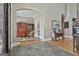 Elegant foyer with stone flooring leads to a formal living area, showcasing the home's luxurious design at 310 Westbourne Dr, Tyrone, GA 30290