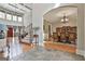 Open-concept foyer with stone tile flows to hardwood, leading to a staircase and a formal dining room at 310 Westbourne Dr, Tyrone, GA 30290