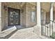 Elegant front entrance with a decorative wrought iron door, brick columns, and manicured landscaping at 310 Westbourne Dr, Tyrone, GA 30290