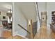 Staircase and hallway leading to dining room; featuring hardwood floors and neutral colors at 310 Westbourne Dr, Tyrone, GA 30290