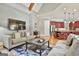 Open-concept living room with a view of the kitchen, featuring hardwood floors and a cozy seating area at 310 Westbourne Dr, Tyrone, GA 30290