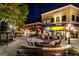 Outdoor seating area with restaurants and shops, illuminated at night at 310 Westbourne Dr, Tyrone, GA 30290