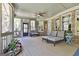 Relaxing screened porch with brick pillars, ceiling fan, and comfortable outdoor furniture at 310 Westbourne Dr, Tyrone, GA 30290