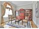 Elegant sitting room with hardwood floors, arched window, and a display cabinet, perfect for relaxing at 310 Westbourne Dr, Tyrone, GA 30290