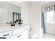 Bathroom features white countertops, a vanity with black fixtures and tub with window view at 10453 Trellis Lane (Lot 28), Hampton, GA 30228