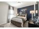 Bedroom features a dark blue accent wall, soft carpet and lots of natural light at 10453 Trellis Lane (Lot 28), Hampton, GA 30228