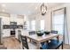 Cozy dining area with modern light fixture and view into the kitchen at 10453 Trellis Lane (Lot 28), Hampton, GA 30228