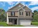 Two-story brick home with attached two-car garage and well-maintained front lawn at 10453 Trellis Lane (Lot 28), Hampton, GA 30228