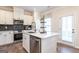 Modern kitchen with stainless steel appliances, white cabinets, and center island with sleek finishes at 10453 Trellis Lane (Lot 28), Hampton, GA 30228