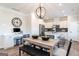 Elegant kitchen with stainless steel appliances and a dining area with modern orb chandelier at 10453 Trellis Lane (Lot 28), Hampton, GA 30228