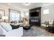 Stylish living room with fireplace, large windows, and comfortable seating arrangement at 10453 Trellis Lane (Lot 28), Hampton, GA 30228