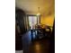 Dining room with dark wood floors, wooden table, a window with blinds, and a decorative light fixture at 120 Wayside Dr, Lawrenceville, GA 30046