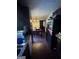 Galley kitchen with dark cabinetry, stainless steel dishwasher, granite countertops, and dining area at the end at 120 Wayside Dr, Lawrenceville, GA 30046