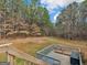 View of the backyard from the wooden deck and stairway with wooded scenery at 180 Collins Way, Locust Grove, GA 30248