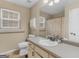 Neutral bathroom showcasing well-lit vanity, sink, and tiled flooring at 180 Collins Way, Locust Grove, GA 30248