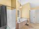 Bright bathroom featuring a soaking tub and separate shower with natural light at 180 Collins Way, Locust Grove, GA 30248