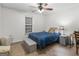 Bedroom with a bed, side table, carpet, and natural light at 180 Collins Way, Locust Grove, GA 30248