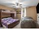 Cozy bedroom features a bunk bed with ceiling fan and natural light at 180 Collins Way, Locust Grove, GA 30248