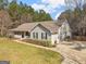Expansive home with a long driveway and ample greenery on the property at 180 Collins Way, Locust Grove, GA 30248