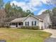 A charming one-story home with a wide front porch and manicured front lawn at 180 Collins Way, Locust Grove, GA 30248