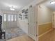 Bright foyer with decorative rug, front door, and hallway leading into the house at 180 Collins Way, Locust Grove, GA 30248