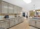 Spacious kitchen featuring granite countertops and wood cabinets, open to the dining area at 180 Collins Way, Locust Grove, GA 30248