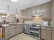 Kitchen with stainless steel appliances and granite countertops connecting to adjacent dining area at 180 Collins Way, Locust Grove, GA 30248