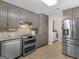 Bright kitchen with stainless steel appliances, sleek countertops, and a view into the laundry room at 180 Collins Way, Locust Grove, GA 30248