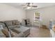 Comfortable living area features a sofa, ottoman, and natural light at 180 Collins Way, Locust Grove, GA 30248