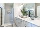 Beautiful bathroom featuring double sinks, modern fixtures, decorative mirror and patterned tile floor at 10410 Trellis Lane (Lot 35), Hampton, GA 30228