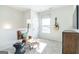 Cozy upstairs loft area with neutral carpet, leather chair, and natural light from the window at 10410 Trellis Lane (Lot 35), Hampton, GA 30228