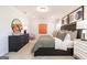 Inviting main bedroom featuring a dark wood bed frame, stylish decor, and lots of natural light at 10410 Trellis Lane (Lot 35), Hampton, GA 30228