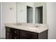 Bathroom vanity with double sinks and granite countertop featuring a large mirror at 220 Long Dr, Mcdonough, GA 30253