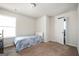 Well-lit bedroom with light colored carpet, window and light blue and purple quilt on the bed at 220 Long Dr, Mcdonough, GA 30253