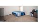 This bedroom includes carpet, a bed with blue comforter, and a basket of personal belongings at 220 Long Dr, Mcdonough, GA 30253