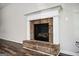 Close-up of a cozy fireplace with a white mantle and brick surround at 220 Long Dr, Mcdonough, GA 30253