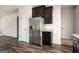 Kitchen area showcases a stainless steel refrigerator, dark wood cabinets, and granite countertops at 220 Long Dr, Mcdonough, GA 30253