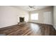 Well-lit living room with hardwood floors, a fireplace, and a front entry at 220 Long Dr, Mcdonough, GA 30253