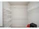 A walk-in closet featuring white wire shelving for organized storage space and a neutral color scheme at 220 Long Dr, Mcdonough, GA 30253