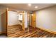 Bedroom with natural wood trim and wood-look floors and walk-in closet at 5735 Archer Ave, Cumming, GA 30041